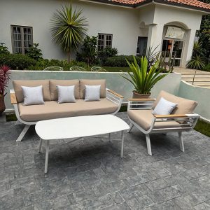 Bộ sofa ngoài trời nhôm trắng, nệm be, bối cảnh sân vườn biệt thự