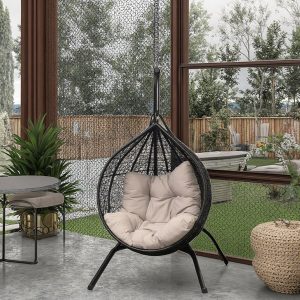 Ghế xích đu trứng giả mây đặt trong không gian sân vườn kính sang trọng