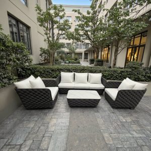 Bộ sofa sân vườn hiện đại, đan dây thủ công, nệm trắng, đặt ở sân nội khu chung cư