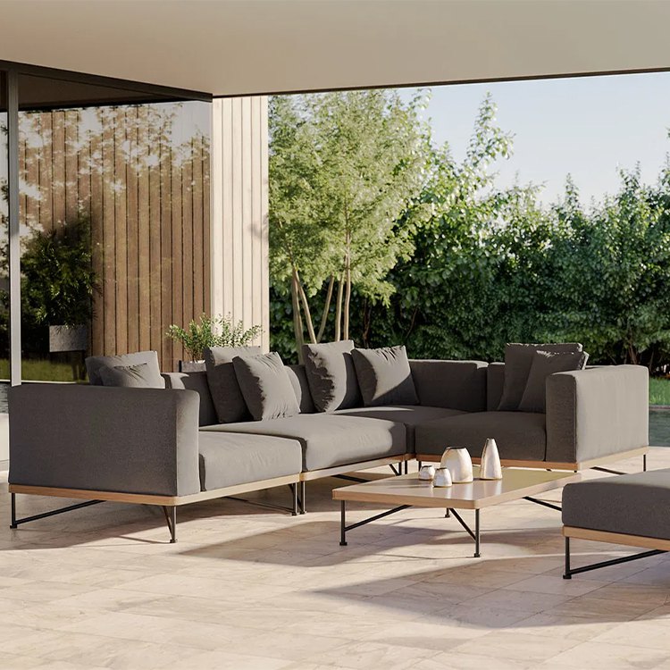 Bộ sofa sân vườn góc L màu xám đậm, phong cách hiện đại đặt ngoài trời cạnh vườn cây