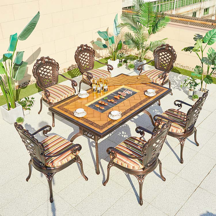 Bộ bàn ghế sân vườn nhôm đúc 7 món, lưng ghế hoa văn cổ điển, mặt bàn tích hợp bếp nướng BBQ